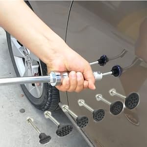 Série d'accessoires de massage en caoutchouc noir installés sur un appareil portatif, montrant des têtes de différentes tailles avec des surfaces texturées.